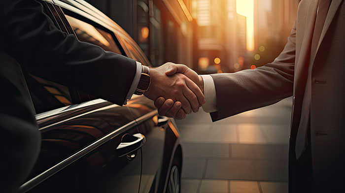 handshake between chauffeur and traveller